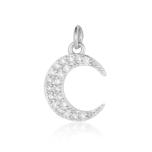 Macro shot of silver crescent moon pendant with inlaid clear zircon stones and a top bail