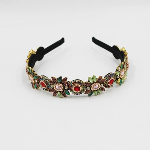 Detailed view of floral headband with colorful rhinestones and crystals on black band