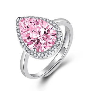 Elegant silver pear shaped ring featuring a large pink zircon center stone with halo accents