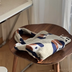 Détail macro du sac cabas en polaire avec motif animal montrant la capacité pour téléphone