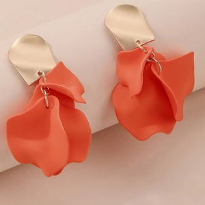 Close-up of elegant coral orange matte rose petal earrings with gold studs
