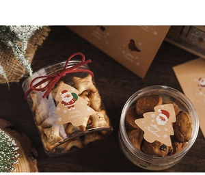 Close-up of Christmas tree kraft paper stickers on festive cookie gift packaging