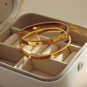 Minimalist gold titanium steel bracelets with starburst zircon inlay in a gift box