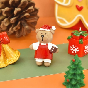 Detailed view of a mini resin Christmas bear figurine with festive holiday decorations