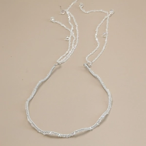 Detailed macro view of silver crystal beaded headband with cascading tassel fringe drops