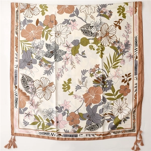 Detail of tropical floral and zebra print silk shawl with corner tassel accents