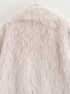 Detailed close-up of soft lavender faux fur texture on woman's luxury winter coat