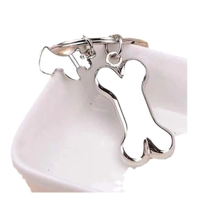 Metal bone and Schnauzer dog charm keychain in silver finish on white ceramic edge