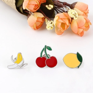 Cartoon fruit enamel brooch set with banana, cherry, and lemon on a floral background