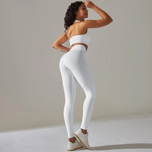 Detail of white seamless knitted yoga set featuring one-shoulder top and high waist leggings