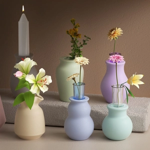 Detailed view of six colorful matte resin molds and candle holders for DIY crafts