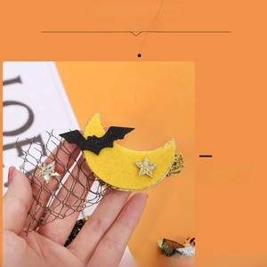 Detail of Halloween hair clip with mesh veil, crescent moon, and bat for party styling