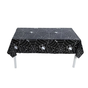 Detailed pattern of white cobwebs and spiders on black Halloween party tablecloth