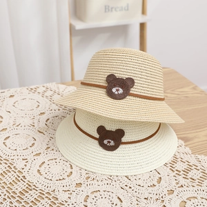 Kids summer straw sun hat featuring a cute knitted bear and adjustable leather strap decor