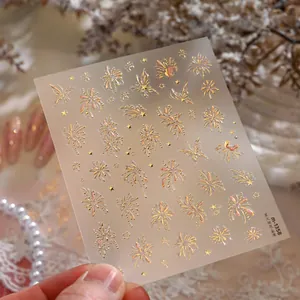 Close-up of M-1358 gold laser firework nail stickers with elegant gradient star patterns