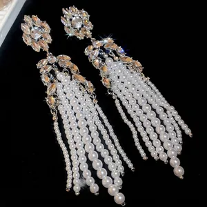 Elegant floral pearl tassel earrings with crystal diamond clusters on black velvet