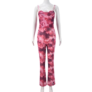Detail of red marble print mesh jumpsuit with thin straps and a flared leg design