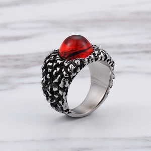 Macro view of vintage stainless steel dragon eye ring with a large red synthetic ruby stone