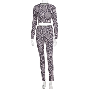 Close-up of purple snakeskin print on long-sleeve crop top and high-waist leggings set