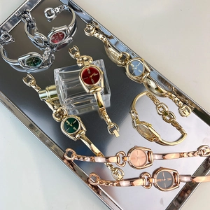 Elegant horsebit quartz watches in gold, silver and rose gold finishes on a metal tray