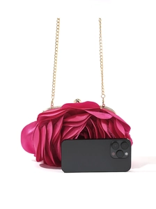Pink floral satin clutch bag with gold chain strap shown next to a phone for scale