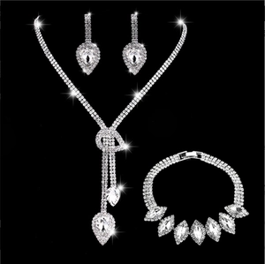Detailed view of silver bridal jewelry set with sparkling teardrop rhinestones on black