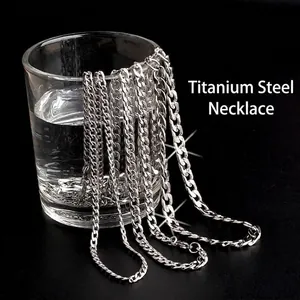 Waterproof silver titanium steel curb chain necklace hanging on a glass of water