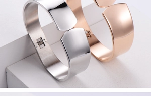 Detailed macro of polished silver and rose gold bangles with internal brushed finish