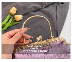 Detail of purple velvet evening bag featuring gold metal handle and floral diamond clasp