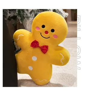 Detail of gingerbread man plush pillow with red bow tie on cozy Christmas rug