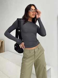 Close-up of slim-fit dark grey long sleeve shirt fabric texture and ribbed round neck