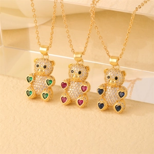 Detail shot of gold-plated bear necklaces featuring green, pink, and blue crystal hearts