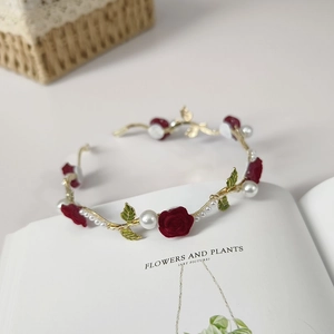 Detail of velvet rose and pearl headband on an open book for an elegant hair accessory
