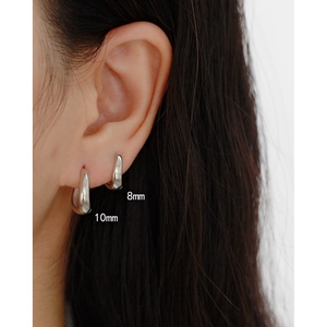 Macro view of minimalist S925 silver irregular geometric earrings in 8mm and 10mm sizes