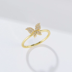 Close-up of a s925 silver butterfly ring in gold finish with clear gemstones