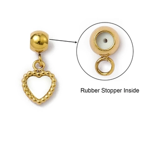 Detail view of heart pendant with gold finish and rubber stopper inside for jewelry