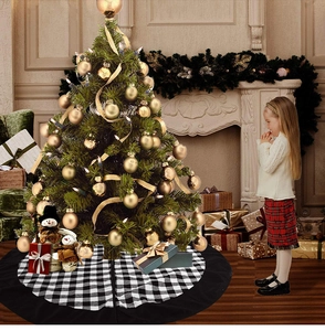 Close-up of black and white plaid Christmas tree skirt under a decorated tree