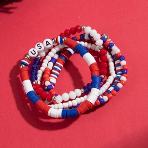 Patriotic red white and blue clay bead bracelets featuring USA letter charms in a set