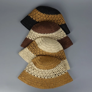 Detailed top view of four handmade crochet bucket hats showing intricate knit textures