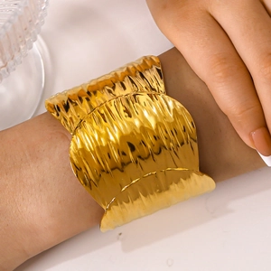 Polished 18k gold-plated stainless steel wide cuff bracelet with wavy textured finish