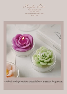 Detailed view of burning succulent and rose shaped scented candles in glass containers