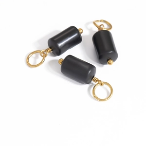 Three vintage black cylindrical natural stone pendants with gold stainless steel finish