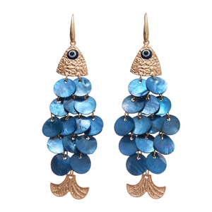 Exquisite gold fish earrings with blue evil eye and iridescent shell tassels on white