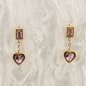 Detail of 18K gold plated earrings featuring rectangle and heart pink zircon pendants