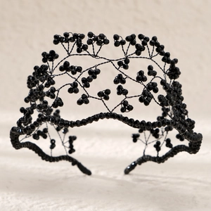 Handmade black crystal bridal headband with intricate beaded mesh design for hair styling