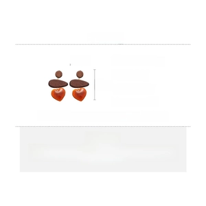 Detail view of resin and wood heart drop earrings with dimensions 7cm by 4cm and silver pins