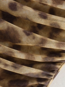 Macro view of leopard print mesh fabric with elegant ruched texture and mesh holes