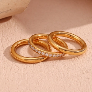 Close-up of three 18K gold plated stainless steel rings featuring one zircon paved band