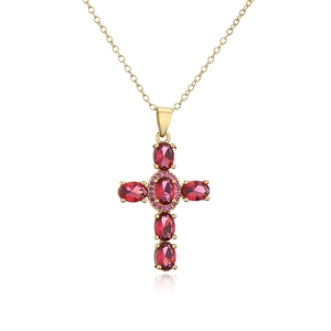 Macro detail of cross pendant with purple oval gemstones and gold plated necklace
