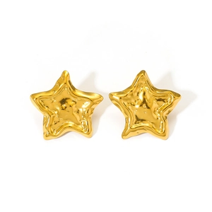 Macro shot of liquid metal style gold star earrings with shiny polished texture